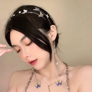 Detailed view of silver butterfly tassel earrings and necklace set on a model