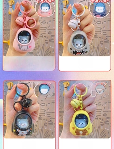 Close-up of cute space cat and bear LED light-up keychains in four pastel colors