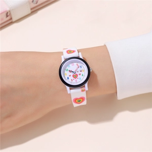 Close-up of kids quartz watch with rainbow heart pattern on white silicone strap