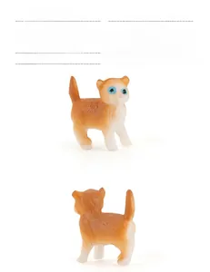 Detailed macro view of a miniature orange and white cat farm animal model figurine