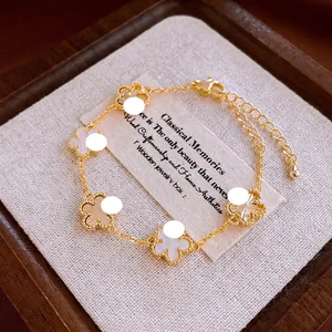 Elegant gold plated clover bracelet with mother of pearl inlays and adjustable chain