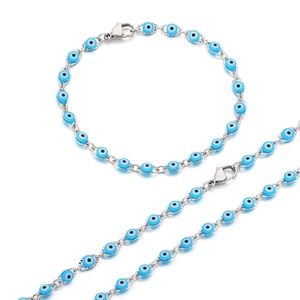 Silver evil eye jewelry set featuring a blue beaded necklace and matching bracelet