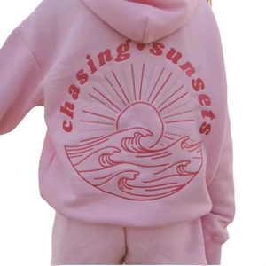 Pink 3D printed hoodie set with chasing sunsets graphic on the back of the sweatshirt