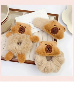 Three-piece set of plush brown and beige Capybara bear hair accessories on a tray