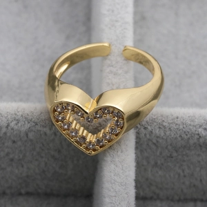 Close-up of gold-plated copper heart ring with cubic zirconia stones on jewelry box