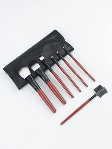 Close-up of 7 pieces mahogany handle makeup brush set with black faux leather wrap bag