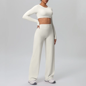 Detail of high-waisted wide-leg athletic pants and cropped long-sleeve yoga top