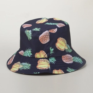 Close-up of tropical pineapple print on deep blue bucket hat with quality stitching detail