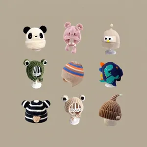 Winter collection of nine cute kids knitted animal hats with earflaps and pom-poms