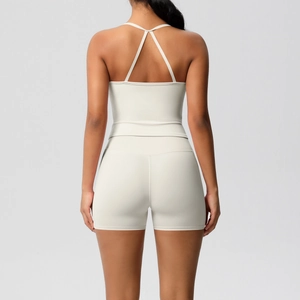 Detail of cross back yoga tank top and high waist sports shorts in creamy white