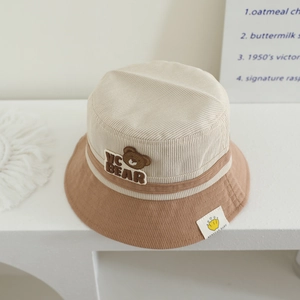 Detailed close-up of corduroy texture and bear patch on kids bucket hat