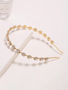 Detailed view of the gold headband featuring sparkling rhinestone sunflower decorations