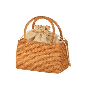 Handmade wicker picnic basket with natural amber fiber weave and cream drawstring liner