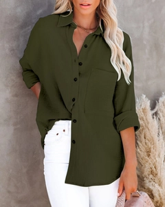 Detail of dark olive green cotton linen shirt texture with buttoned front and pocket