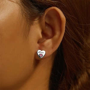 Close-up of S925 sterling silver heart earring with Sister engraving and pink zircon