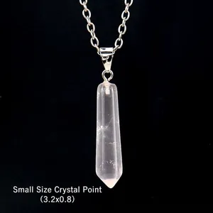 Detail view of a small 3.2x0.8 cm clear quartz hexagonal point pendant on a silver chain