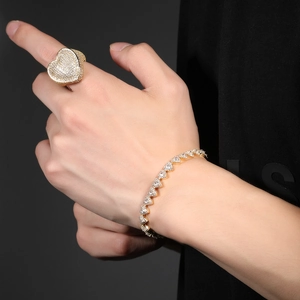 Macro shot of gold-plated hip hop ring and bracelet set with AAA heart-shaped zircons