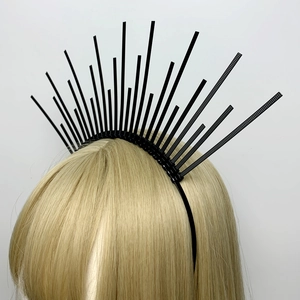 Detail view of a black sunburst crown headband styled on golden blonde hair for a costume look