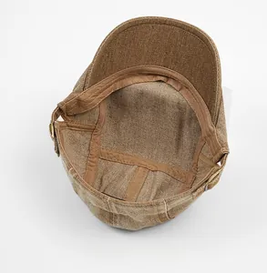 Internal detail of washed cotton cap showing fabric texture and metal adjustment buckle