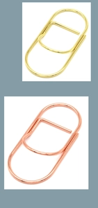 Detail of rose gold and gold paperclip style metal pen holders for notebooks