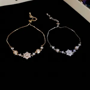 Elegant snowflake charm bracelets in gold and silver finish with sparkling zircon stones