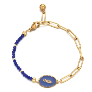 Detail of golden stainless steel bracelet featuring blue beads and a feather pendant
