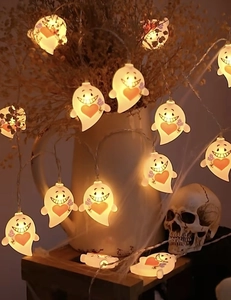 Close-up of ghost LED string lights with warm glowing hearts for Halloween decor