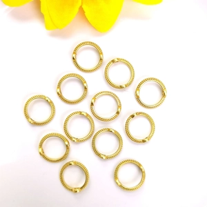 Macro detail of textured 14k gold-filled jewelry rings for DIY earrings and necklaces