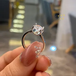 Close-up of a classic four-prong silver ring with a large brilliant round zircon stone