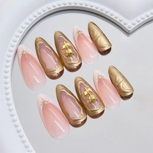 Faux ongles amandes avec relief 3D or rose et motifs étoilés étincelants