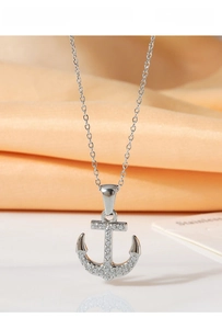 Macro shot of silver titanium steel anchor pendant with sparkling zircon detail