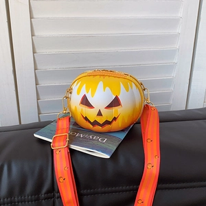Close-up of Halloween pumpkin round bag with jack-o'-lantern face and striped strap