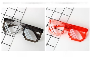 Detail showing black and red pixel mosaic sunglasses with transparent plastic frames