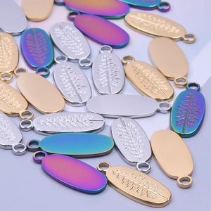 Detailed oval metal pendants with tree relief in gold, silver and rainbow finishes