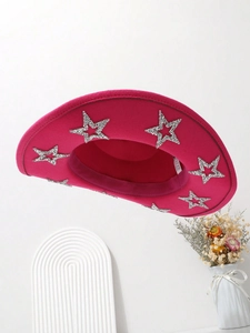 Detail of rose pink cowboy hat with silver sequin stars on a minimalist white backdrop
