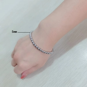 Detailed view of 5mm silver stainless steel beaded bracelet on model wrist