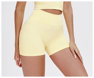 Close-up of lemon yellow high waist seamless yoga shorts with textured knit fabric