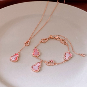 Macro detail of rose gold wulu bracelet and necklace set with mother of pearl and zircon