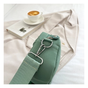 Close-up of mint green Oxford cloth shoulder bag with premium silver metal hardware hooks