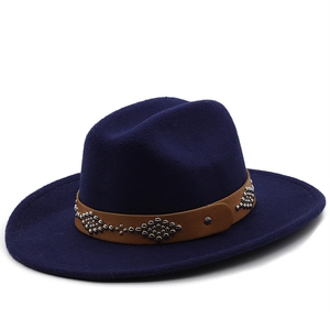 Close-up of navy blue wool fedora hat with brown leather belt and silver studded details