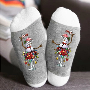 Christmas socks featuring snowman in wine glass with holiday lights and gift pattern
