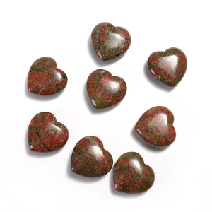 Top view of eight polished heart-shaped green and red jasper natural gemstone stones