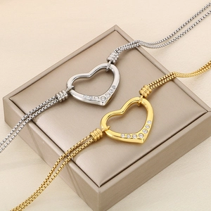 Chic gold and silver hollow heart necklaces with inlaid diamonds on a leather jewelry box