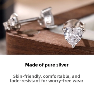 Macro shot of 925 sterling silver heart earrings with sparkling cubic zirconia stones