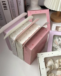 Detailed view of elegant hair scrunchies inside a premium window gift box with patterns
