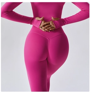 Close-up of V-shaped back stitching on rose pink high-waist yoga pants for lifting