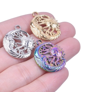 Macro view of sun and moon stainless steel charms in silver gold and rainbow finishes