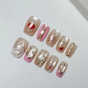 Handmade champagne gold and pink cat-eye press-on nails with heart and moon relief art