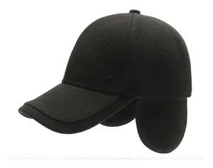 Side view of men's winter wool baseball cap in black with warm ear flaps and K logo