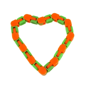 Close-up of colorful wacky tracks snap link toy shaped into a heart on white background